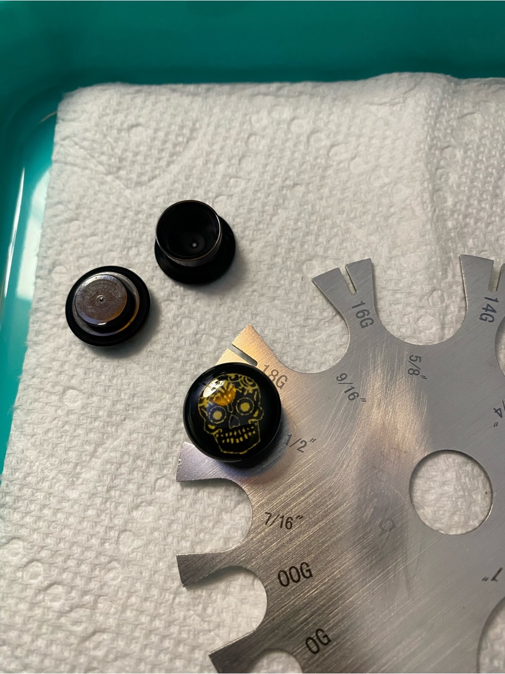 Black Ear Plug with Yellow Skull Design
